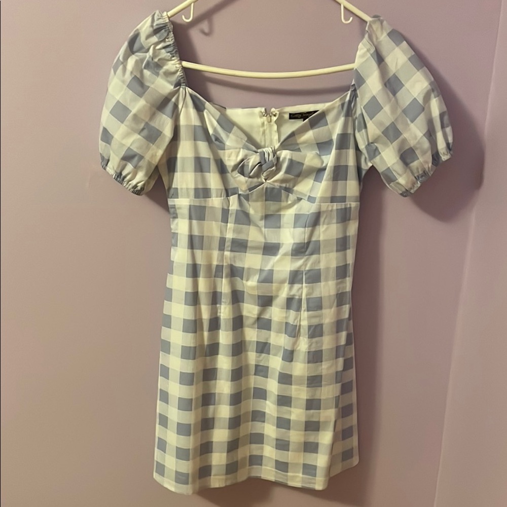 Light blue and white gingham dress with puff sleeves and a bow